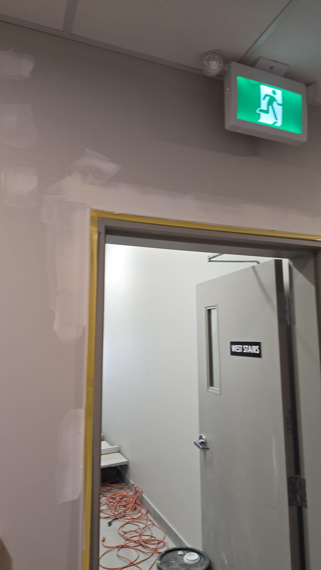 Door frame masked with yellow tape during work Edmonton